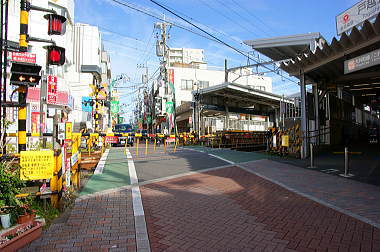 駅前の踏切を渡る